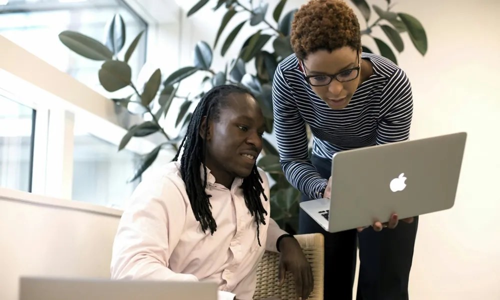 EagleNet technology professionals collaborating on a laptop