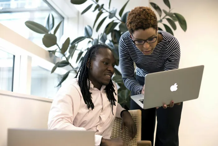 EagleNet technology professionals collaborating on a laptop